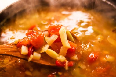 Cooking vegetable soup in saucepan, comfort food and homemade meal concept