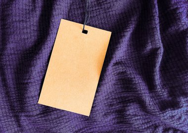 Blank fashion label tag, sale price card on luxury fabric background, shopping and retail concept