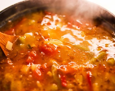 Cooking vegetable soup in saucepan, comfort food and homemade meal concept