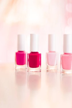 Shades of pink and red nail polish set on glamour background, nailpolish bottles for manicure and pedicure, luxury beauty cosmetics and make-up brand ad