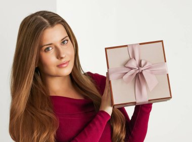 Holiday present for birthday, baby shower, wedding or luxury beauty box subscription delivery, happy woman holding a wrapped pink gift on white background