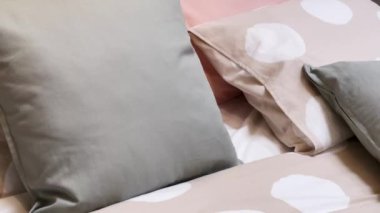 Modern style bedding on bed in bedroom, interior design detail