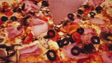 Pizza capriciosa with cheese stuffed crust in pizzeria, food close-up