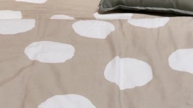 Modern style bedding on bed in bedroom, interior design detail
