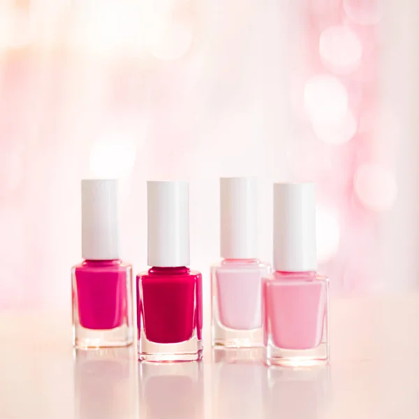 Shades of pink and red nail polish set on glamour background, nailpolish bottles for manicure and pedicure, luxury beauty cosmetics and make-up brand ad