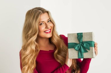 Happy woman holding a gift for birthday, anniversary, wedding, Valentines day or Christmas, luxury holiday present or beauty box subscription delivery concept