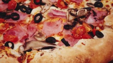 Pizza capriciosa with cheese stuffed crust in pizzeria, food close-up