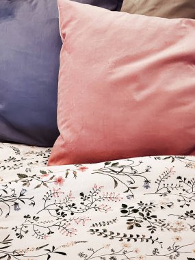 Vintage countryside style bedding with floral pattern on wooden bed in bedroom, interior design detail