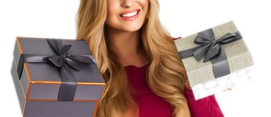 Birthday, Christmas gifts or holiday present, happy woman holding gift boxes isolated on white background, portrait