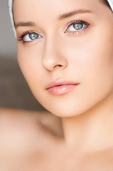 Skin care and beauty routine, beautiful woman with white towel wrapped around head, skincare cosmetics and face cosmetology, close-up portrait