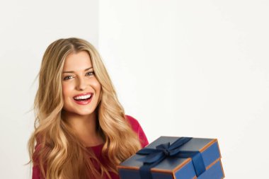 Happy woman with a gift falling in her hands for birthday, anniversary, wedding, Valentines day or Christmas, luxury holiday present or beauty box subscription delivery concept