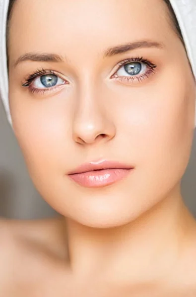 Skin care and beauty routine, beautiful woman with white towel wrapped around head, skincare cosmetics and face cosmetology, close-up portrait