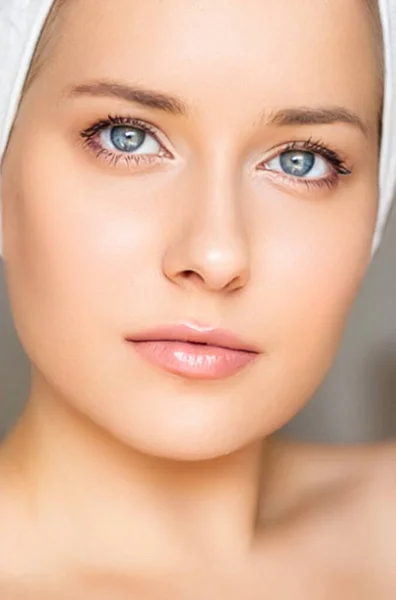 Skin care and beauty routine, beautiful woman with white towel wrapped around head, skincare cosmetics and face cosmetology, close-up portrait