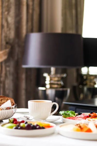 Luxury hotel and five star room service, various food platters, bread and coffee as in-room breakfast for travel and hospitality brand