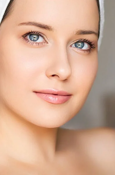 Skin care and beauty routine, beautiful woman with white towel wrapped around head, skincare cosmetics and face cosmetology, close-up portrait