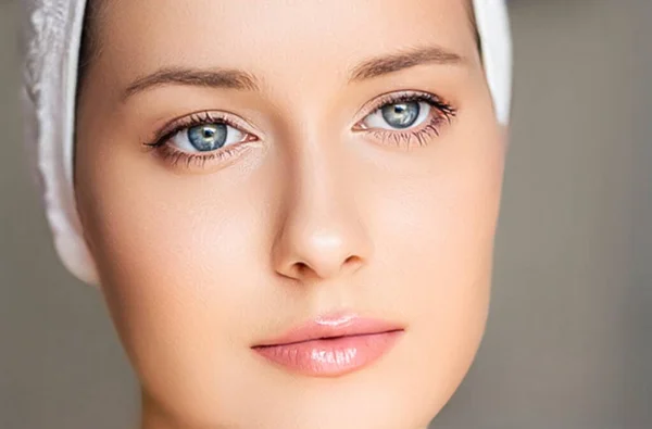 Skin care and beauty routine, beautiful woman with white towel wrapped around head, skincare cosmetics and face cosmetology, close-up portrait