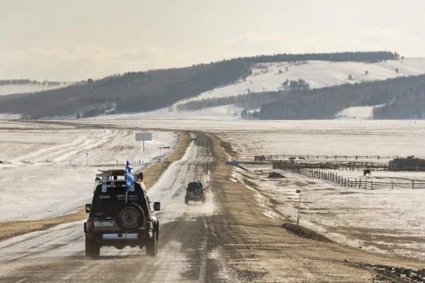 SUV trucks on winter Baikal lake — Stock Photo, Image