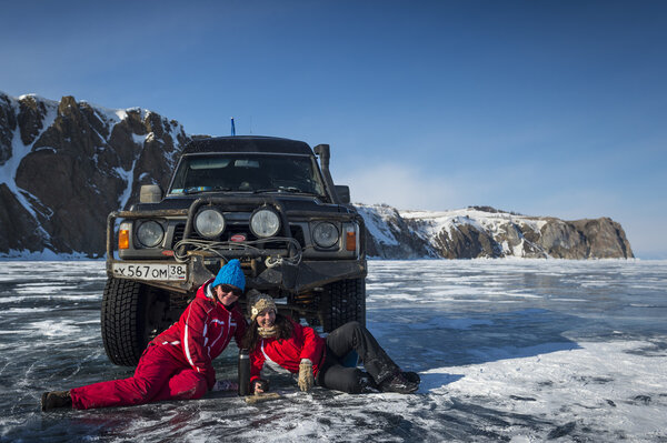 Photo by SUV truck on winter Baikal lake