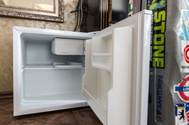 Mini fridge in hotel room clipart