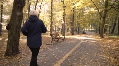 Healthy elderly female enjoying jogging outdoors