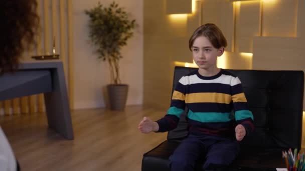 Cute little boy on appointment with kid counselor — Stock videók