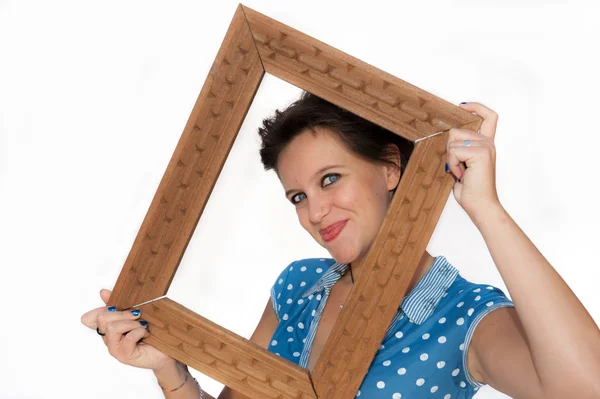 Girl smiling through picture frame — Stock Photo, Image