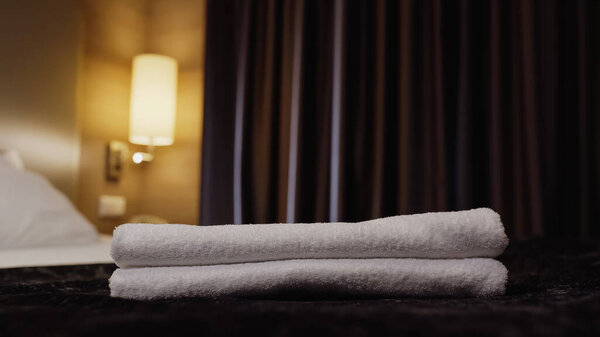 fresh and clean towels on hotel bed