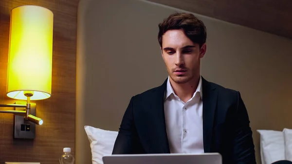 Serious Young Businessman Using Laptop Hotel Room — Stock Photo, Image