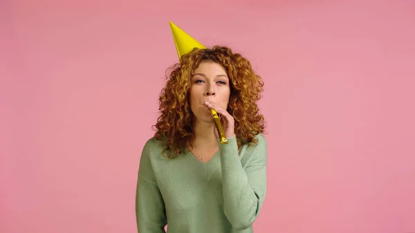Cheerful Redhead Woman Party Cap Blowing Party Horn Isolated Pink — Stockfoto