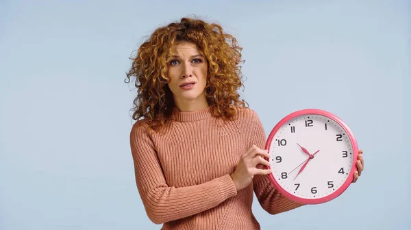 Displeased Woman Holding Clock Looking Camera Isolated Blue — Stockfoto