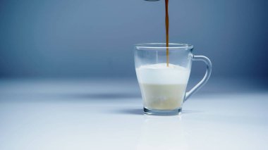 coffee pouring into milk on white and grey  clipart