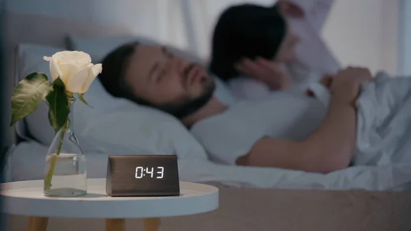 Flower Clock Bedside Table Blurred Man Sleeping Wife Night — Stock Photo, Image