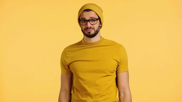 Nespokojený Mladý Muž Čepici Brýlích Tričku Izolovaných Žluté — Stock fotografie