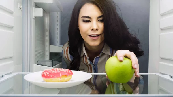 Happy Woman Taking Green Apple Doughnut Fridge — Stock Fotó