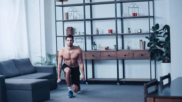 Muscular Sportsman Training Dumbbells Home — Stockfoto