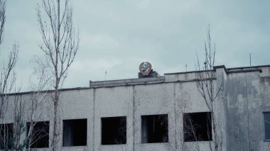 old building and trees in chernobyl abandoned city under grey sky