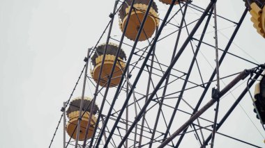 low angle view of ferris wheel in chernobyl amusement park against grey sky clipart