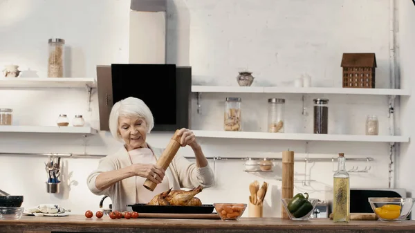 Smiling Senior Woman Seasoning Roasted Turkey Fresh Vegetables Oil Table — Stock Photo, Image