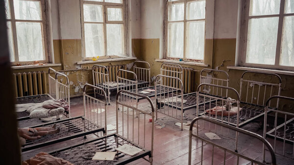 interior of abandoned kindergarten with metal beds in chernobyl exclusion zone