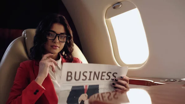 Young Businesswoman Reading Blurred Newspaper Private Plane — Fotografia de Stock