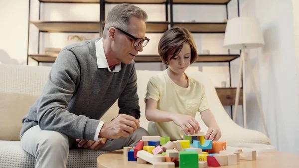 Middle Aged Grandfather Glasses Playing Building Blocks Preteen Boy — Stock Photo, Image