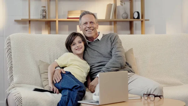 Middle Aged Grandfather Smiling Happy Grandson While Watching Movie Home — Stock Photo, Image