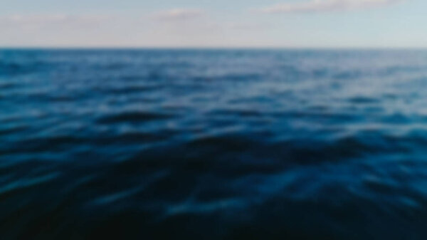 Blurred shot of sea and sky at background 