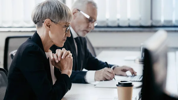 Sidovy Över Mogna Affärskvinna Med Spända Händer Tittar Laptop Kontoret — Stockfoto