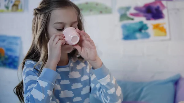Preteen Girl Pajama Drinking Tea Blurred Bedroom — стоковое фото
