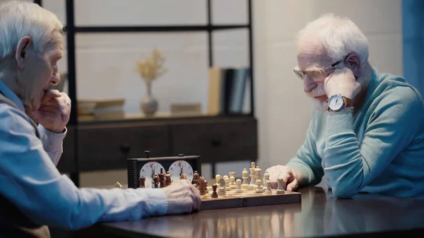 Pensive Senior Man Playing Chess Friend Home — Zdjęcie stockowe