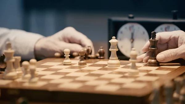 Partial View Senior Men Playing Chess Blurred Chessboard — 图库照片