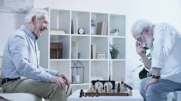Side View Senior Man Thinking Chessboard Laughing Friend — 图库照片