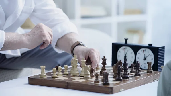 Cropped View Senior Man Moving Chess Figure While Gaming Home — Foto de Stock
