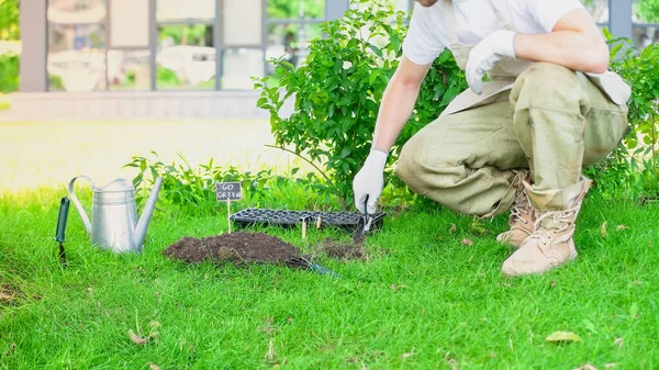 Cropped View Gardener Gloves Holding Shovel Soil Watering Can Garden — Foto de Stock